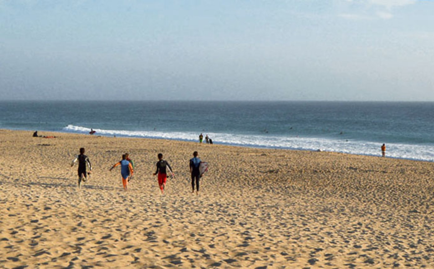 Surfers at Supertubos beach in Peniche